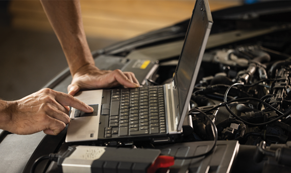 specialist inspecting the vehicle in order to find broken components and errors in data logs