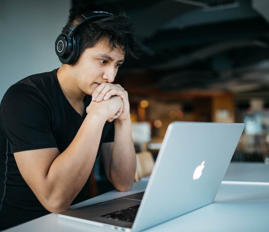 Employee with Headset on looking at a Laptop